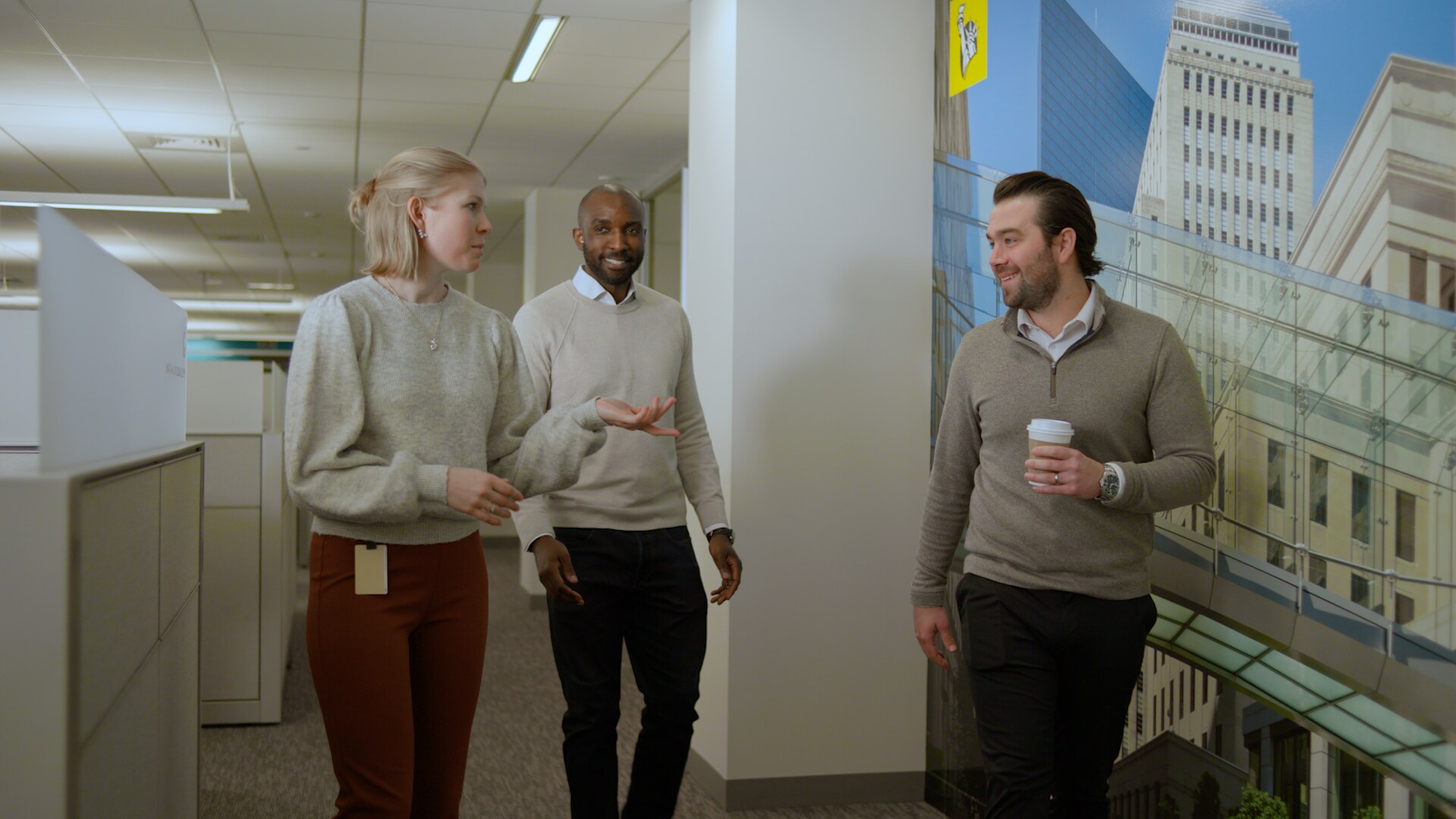 Group of employees standing and chatting in an office setting