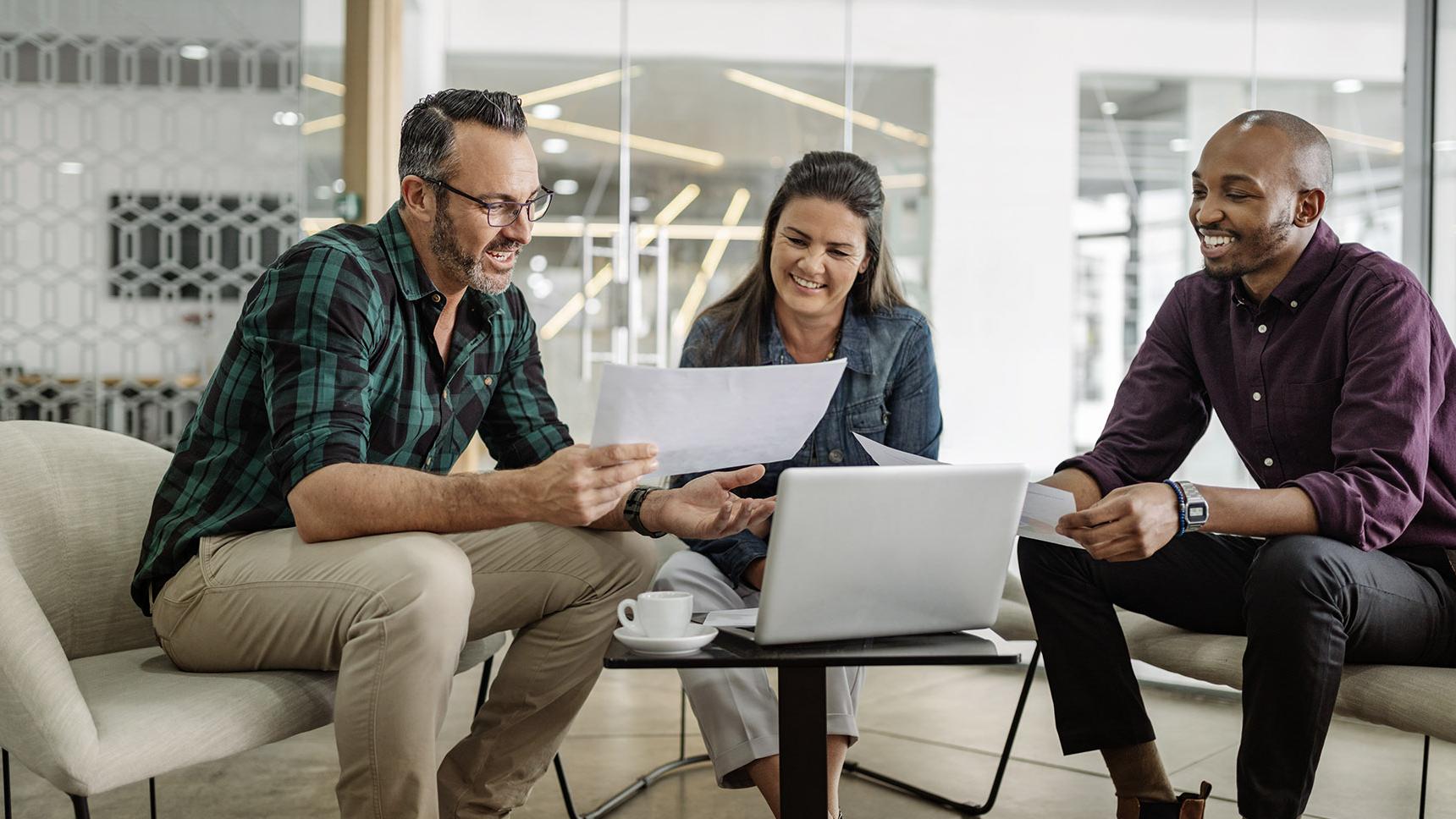 A group meeting over paperwork in an open office concept