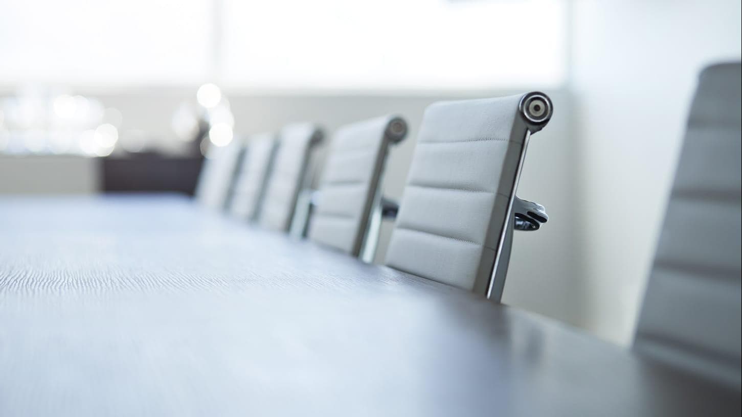 Close up image of chairs in a board room