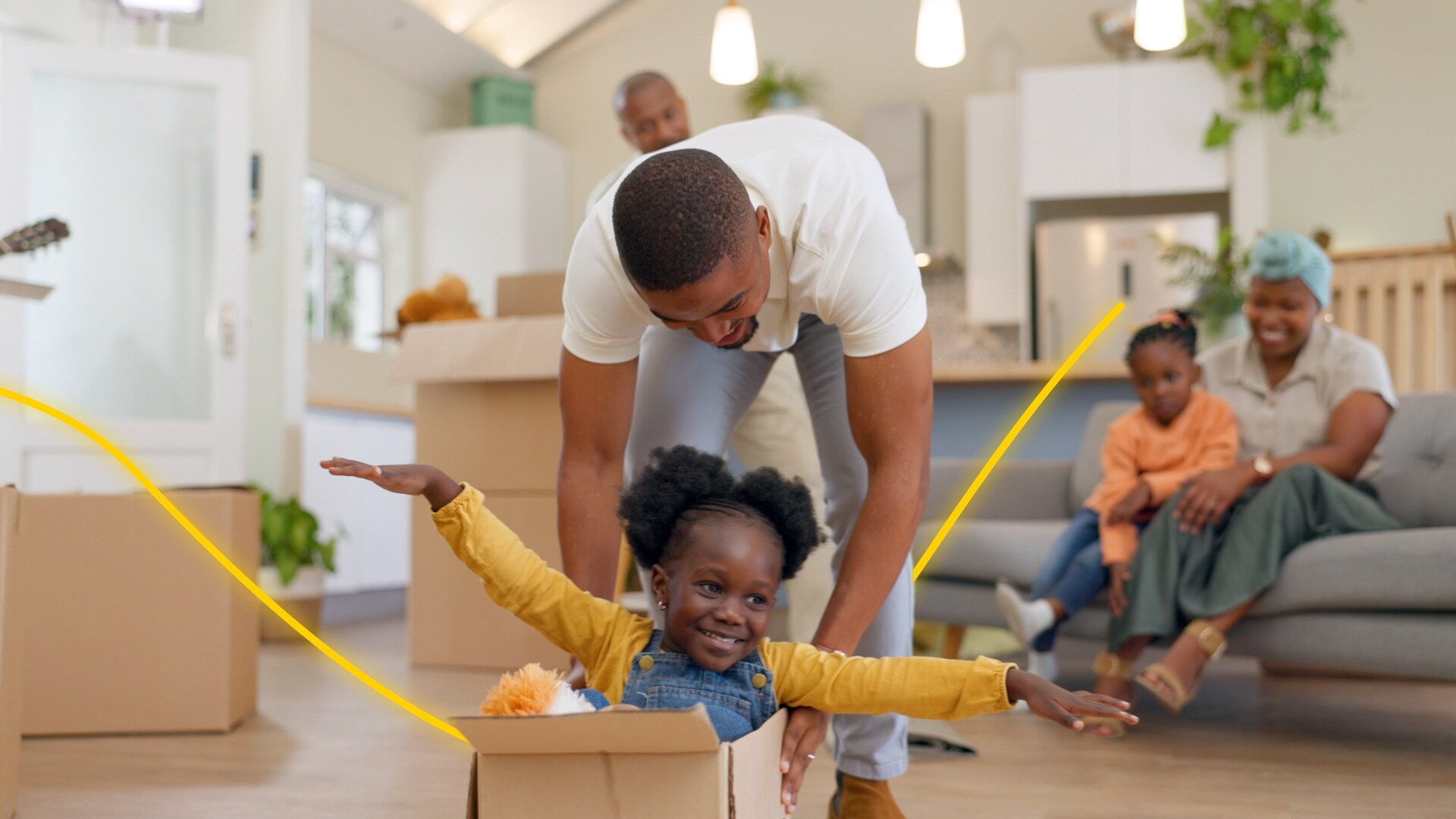 A father and child playing with boxes as they move into their new home